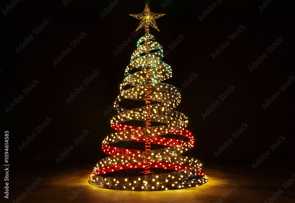 The Christmas tree is made entirely of glowing ribbon arranged in a spiral on a dark background.