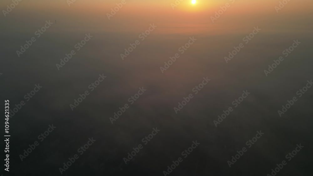 Sunrise casting warm light over a misty landscape with a hazy, tranquil atmosphere Sunrise casting warm light over a misty landscape with a hazy, tranquil atmosphere
