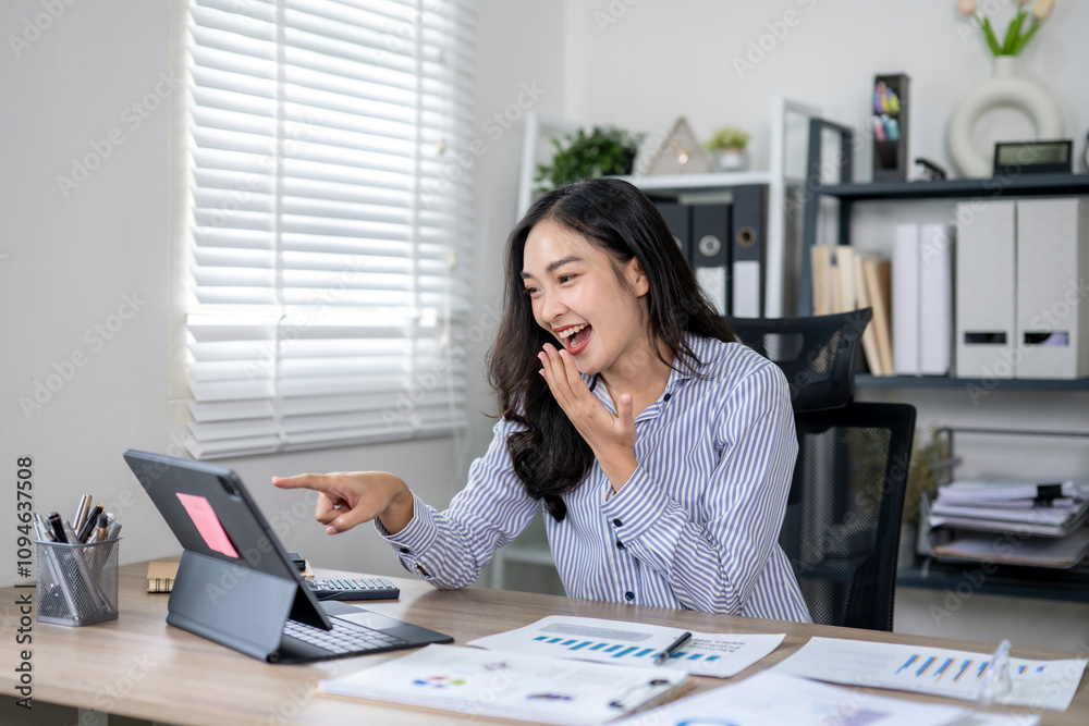 Excited asian businesswoman having video call on tablet in office Excited asian businesswoman having video call on tablet in office