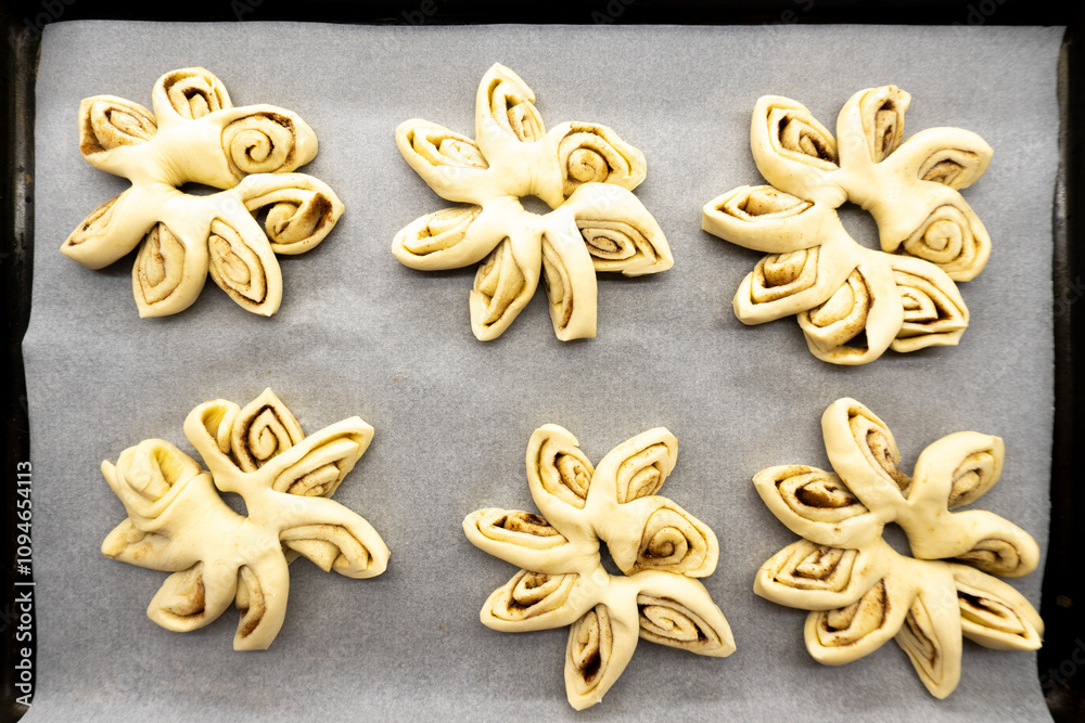 Puff pastry flowers with cinnamon sugar.Puff pastry. Dessert. Cinnamon. Sugar. Food concept Puff pastry flowers with cinnamon sugar.Puff pastry. Dessert. Cinnamon. Sugar. Food concept