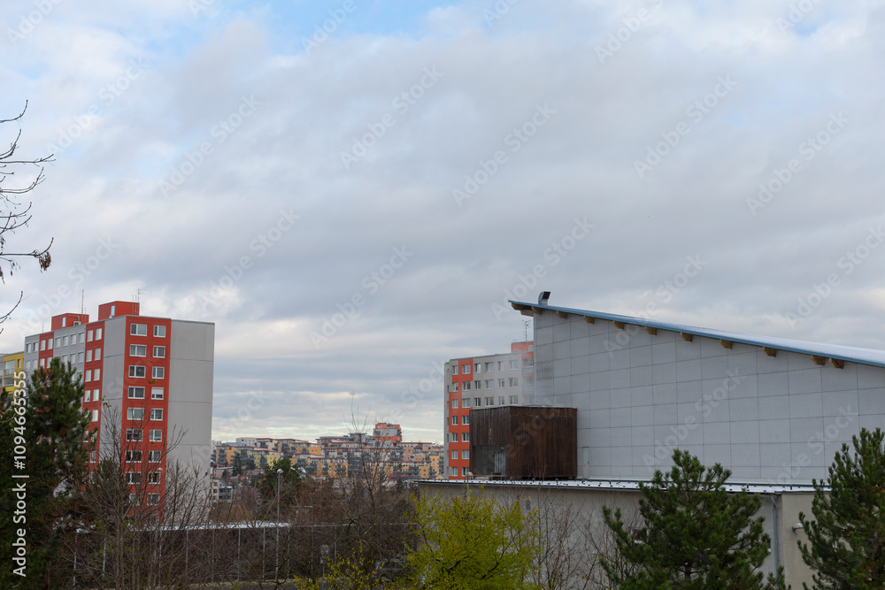 The image showcases urban buildings under a beautiful, cloudy sky, emphasizing residential architecture The image showcases urban buildings under a beautiful, cloudy sky, emphasizing residential architecture