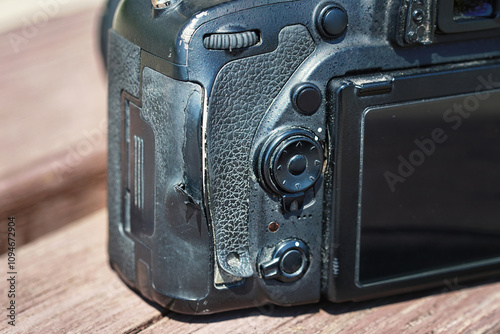 Damaged rubber grip peeling off, need for replacement. Failing rubber grip on DSLR, SLR camera, issues like peeling, detachment, and damage over time. Common rubber parts damage like peeling photo