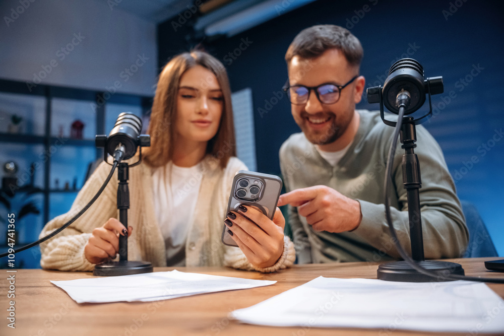 Man and woman are sitting. Radio hosts recording podcast Man and woman are sitting. Radio hosts recording podcast