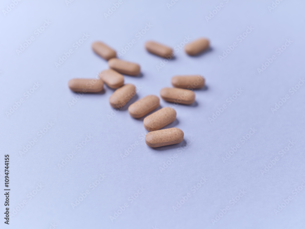 Ashwagandha (Withania somnifera) tablets on paper background. Soft focus. Close up. Copy space. Ashwagandha (Withania somnifera) tablets on paper background. Soft focus. Close up. Copy space.