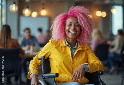 Inclusive image of a happy mixed race lesbian employee sitting in a wheelchair laughing with colleagues in a team meeting. Disabled black working woman with pink hair. Inclusion & diversity workplace photo