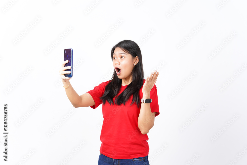 beautiful Asian woman displays a shocked expression while staring at her smartphone screen against a white background beautiful Asian woman displays a shocked expression while staring at her smartphone screen against a white background