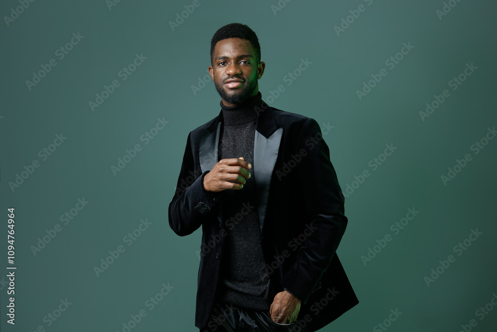 Elegant african american man in black tuxedo posing confidently for formal event or special occasion Elegant african american man in black tuxedo posing confidently for formal event or special occasion