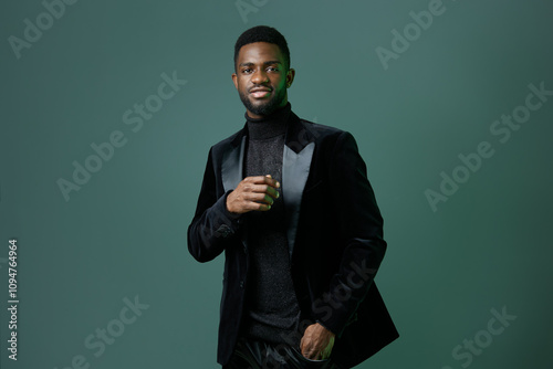 Schilderij op canvas Elegant african american man in black tuxedo posing confidently for formal event