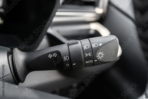 Close-up view of the car headlight switch controls.