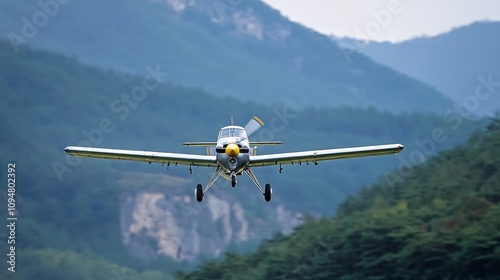 A propeller plane executing a precision knife edge flight maneuver against the stunning backdrop of a towering mountain range showcasing the aircraft s agility the pilot s skill photo