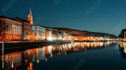 Serene Night View of Historic Waterfront Buildings Illuminated by Street Lights Reflecting on Calm Water in a Picturesque European City