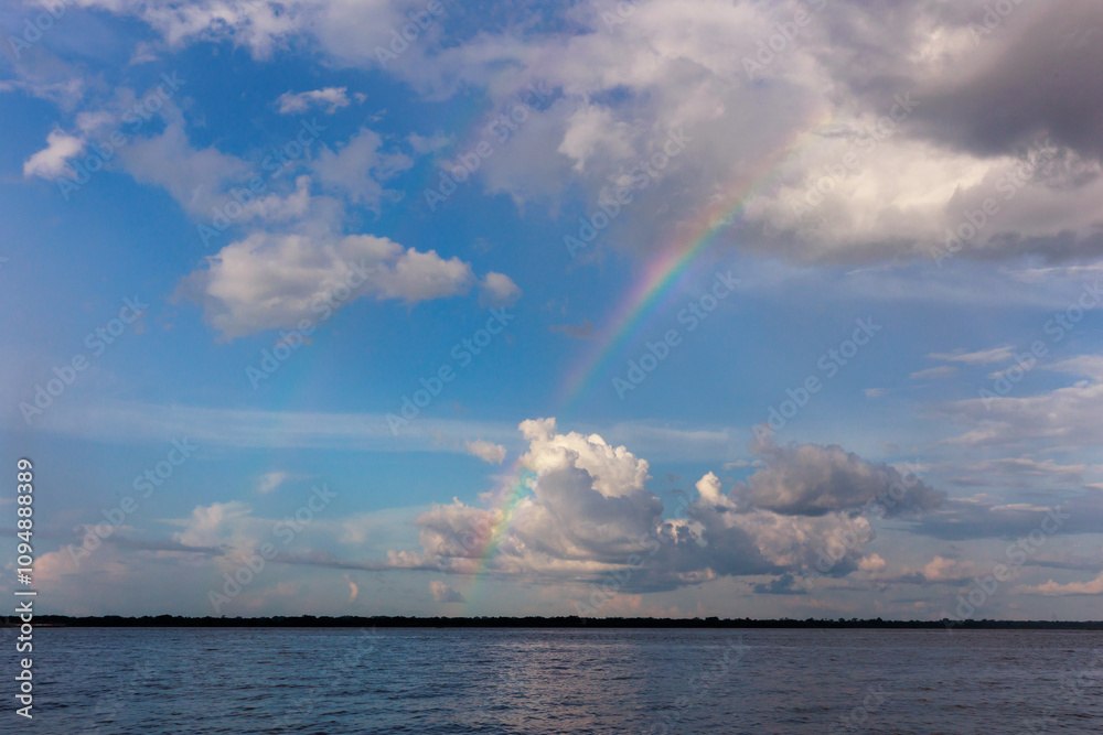 Rainbow in the amazon sky, over the great amazon river, Iquitos Peru Rainbow in the amazon sky, over the great amazon river, Iquitos Peru