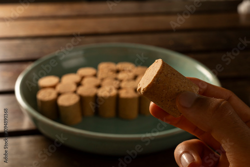 A guy's hand taking one Sweet Brazilian Peanut Called Paçoca