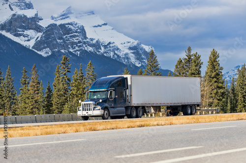Heavy Cargo on the Road. A truck hauling freight along a highway. Taken in Alberta, Canada