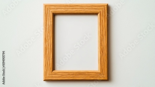 An empty wooden photo frame on a neutral background, perfect for artistic displays and personal creations.