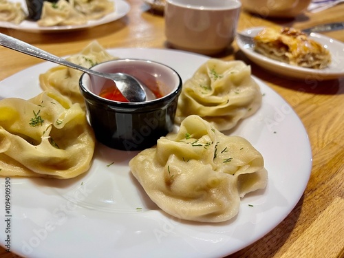 uzbek cuisine manti with sauce close-up in a restaurant dinner for two authentic