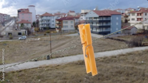 A clothespin swinging on a clothesline,