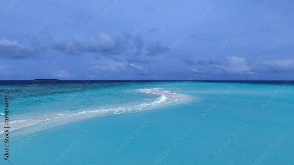 A girl walking on a sandbar in the ocean A girl walking on a sandbar in the ocean