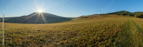 Landscape of Beskid Niski mountains. Pastures, meadows, and forested hills. Rays of the rising sun. Areas of a non-existent Lemko village. Rising Regietow Wyżny, Poland, Europe. HDR panorama. photo