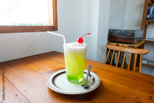 Melon soda float with vanilla ice cream and cherry on top in summer time,Melon soda is one of the most popular Japanese drink,Japanese cafe menu.