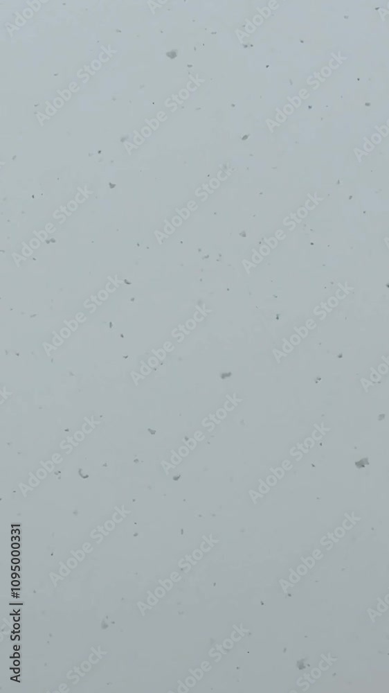 wet snow covers the streets and houses of a small town on Christmas. Snowfall and the magical atmosphere of the new year on holidays. White roofs of rural chalets in the mountains