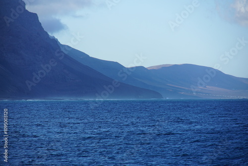 View on Famara cliffs from the ferry, La Graciosa, canary islands, lanzarote, volcanic rocks, november 2024, holiday, nature, mountain, volcanic island, wild birds