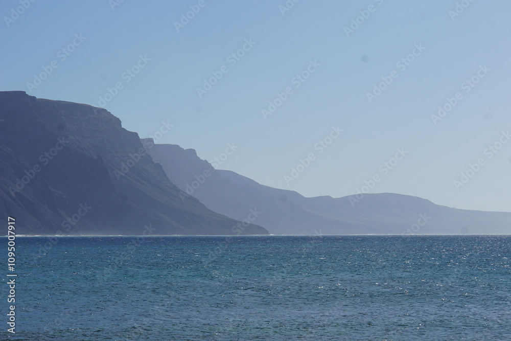 View on Famara cliffs from La Graciosa, canary islands, lanzarote, volcanic rocks, november 2024, holiday, nature, mountain, volcanic island, caleta del sebo View on Famara cliffs from La Graciosa, canary islands, lanzarote, volcanic rocks, november 2024, holiday, nature, mountain, volcanic island, caleta del sebo