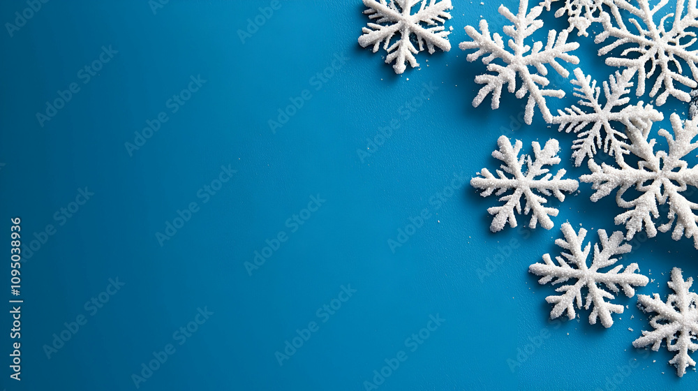 A collection of white snowflakes scattered on a bright blue background, evoking a wintery and festive atmosphere. A collection of white snowflakes scattered on a bright blue background, evoking a wintery and festive atmosphere.