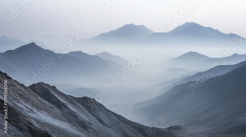 A mountain range shrouded in smog, where the peaks are barely visible, and the surrounding valleys are filled with gray haze. 