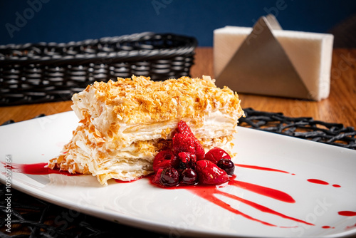 Canvas Print napoleon cake with berries and sauce