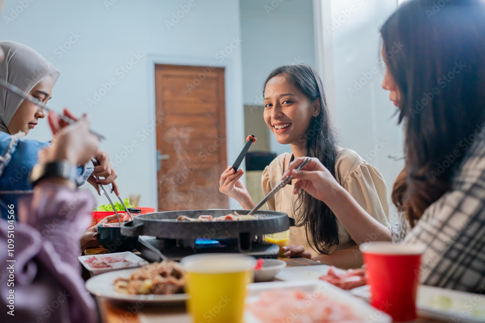 Ταπετσαρία A lively group of friends is sharing a delicious meal, laughing and bonding joyf