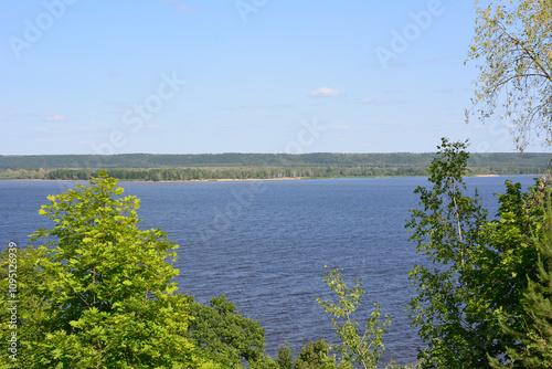 Fototapeta Naklejka Na Ścianę i Meble -  a view of a lake from the top of a hill with some trees