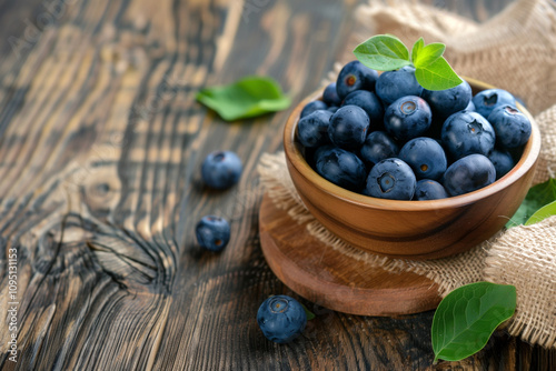 freshly picked blueberries in wooden bowl, selective focus photo