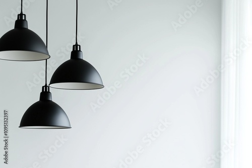 Modern minimalist black hanging lamps in the interior of a home or office, close-up. Copy space, free space for text