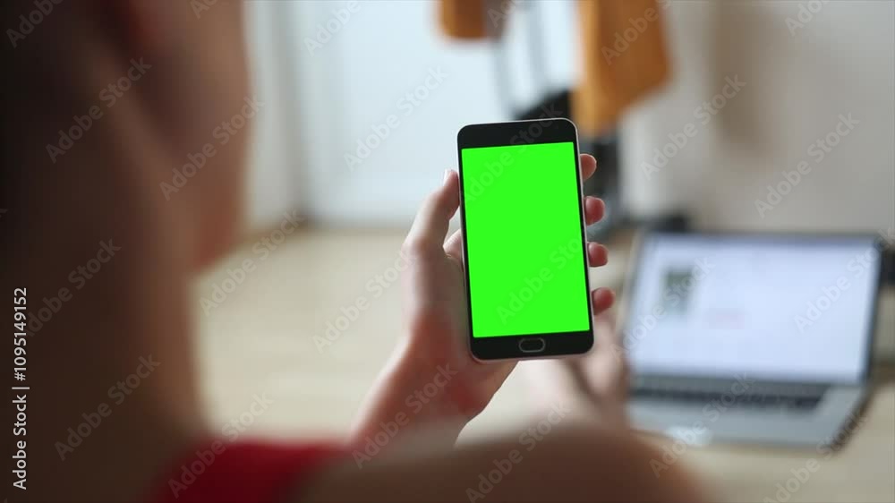 person using mobile phone, Shopping center. Department store. Mall. Back view of brunette holding chroma key green screen smartphone watching content. Shopping online. Gadgets and contemporary people person using mobile phone, Shopping center. Department store. Mall. Back view of brunette holding chroma key green screen smartphone watching content. Shopping online. Gadgets and contemporary people