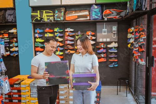 Wallpaper Mural asian athletic footwear sellers holding shoe box and checking product Torontodigital.ca