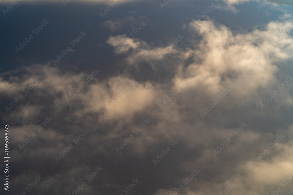 Clouds drifting in a serene sky during sunset near a peaceful rural landscape