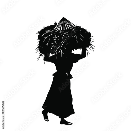 a person carrying a large bundle of hay on their head. The person is wearing a traditional conical hat and a long skirt,