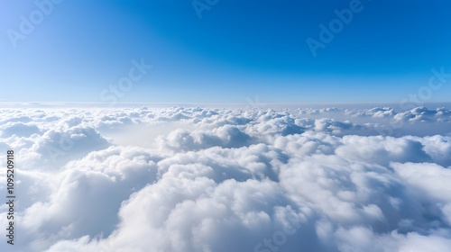 A panoramic view of fluffy white clouds against a bright blue sky.