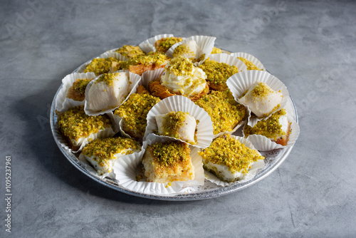 A view of a catering tray of a mix of kunafa, halawet el jibn, shaabiyat, aish el saraya. photo