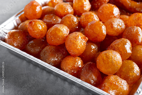 A view of a catering tray of awamat pastries. photo