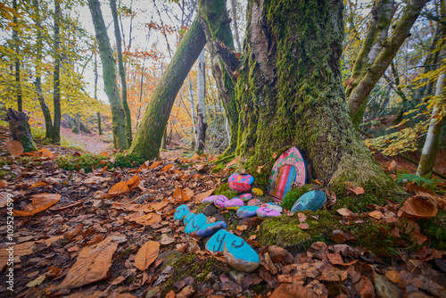 a childs fiary house with wooden door in a tree in woodland autumn color