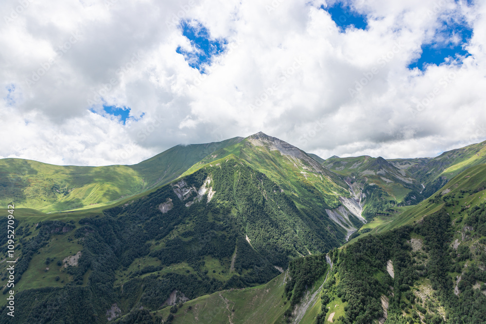 Caucasian mountains near Gergeti village, Stepansminda. Kazbegi mountain behind the clouds. Georgia