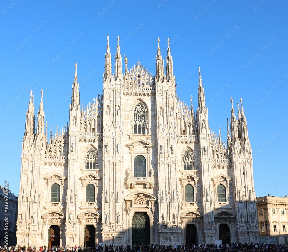 main Facade of Cathedral of Milan also called DUOMO DI MILANO in italian language in gothic style with sky main Facade of Cathedral of Milan also called DUOMO DI MILANO in italian language in gothic style with sky