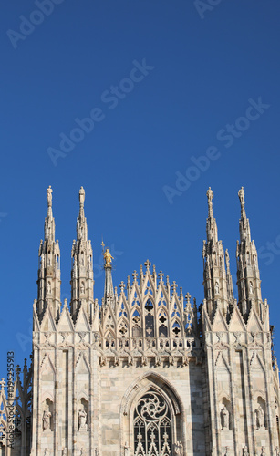 Detail of Facade of Cathedral of Milan also called DUOMO DI MILANO in italian language in gothic style with sky