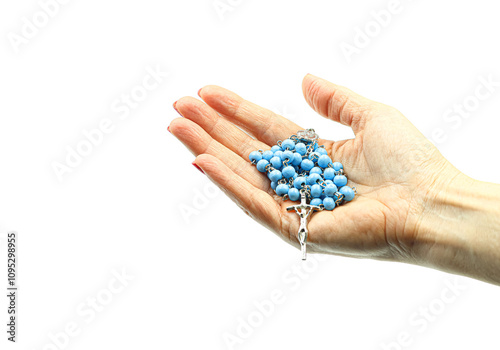 Woman's hands holding a rosary with blue beads. photo