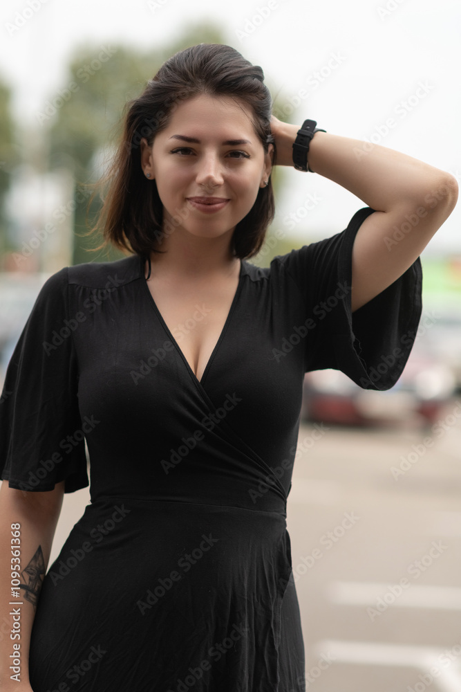 Portrait of a young beautiful dark-haired girl in an urban environment in summer. Portrait of a young beautiful dark-haired girl in an urban environment in summer.