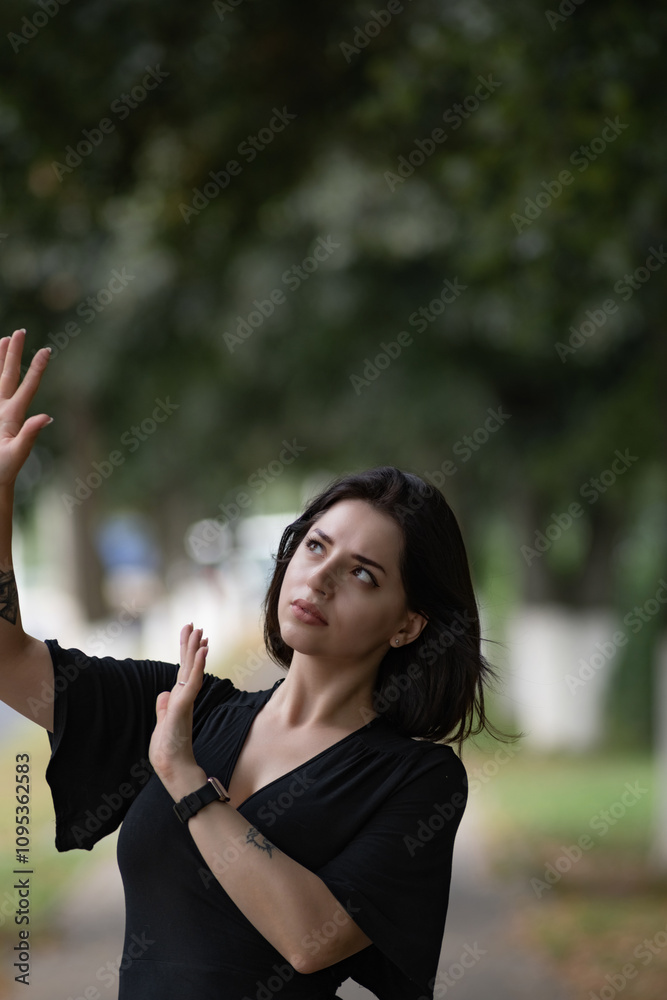 Portrait of a young beautiful dark-haired girl in an urban environment in summer. Portrait of a young beautiful dark-haired girl in an urban environment in summer.