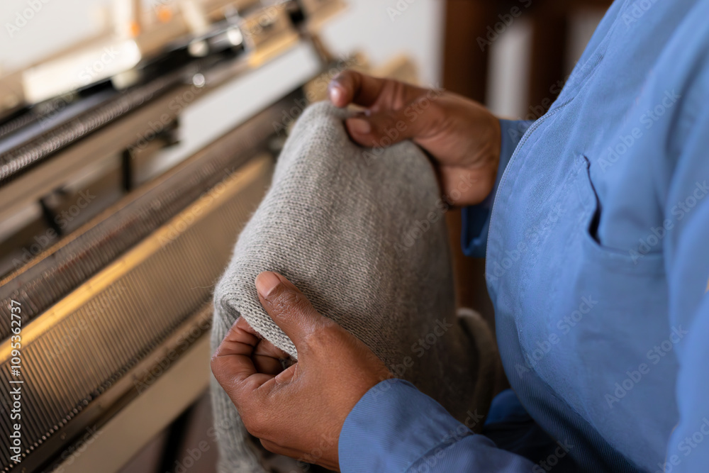Woman textile worker using weaving machine with patterns on a piece of fabric Woman textile worker using weaving machine with patterns on a piece of fabric