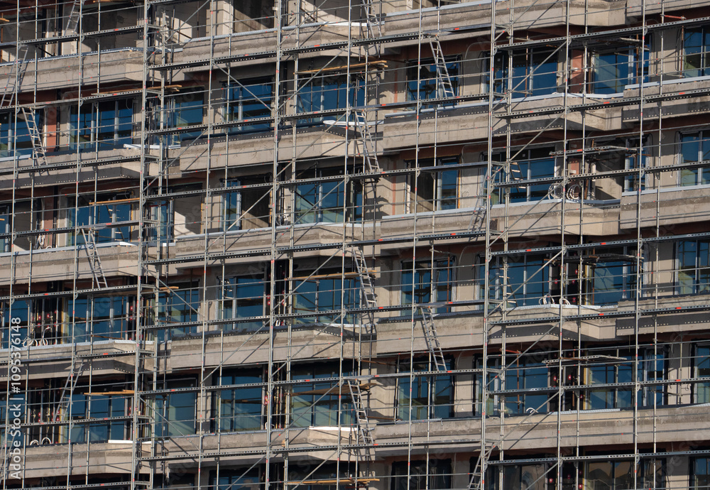 Metal scaffolding on the facade of a building under construction Metal scaffolding on the facade of a building under construction